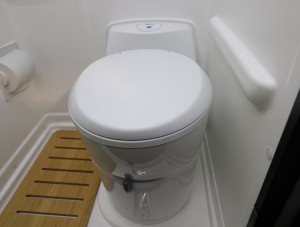 Swiveling toilet inside the bathroom. 